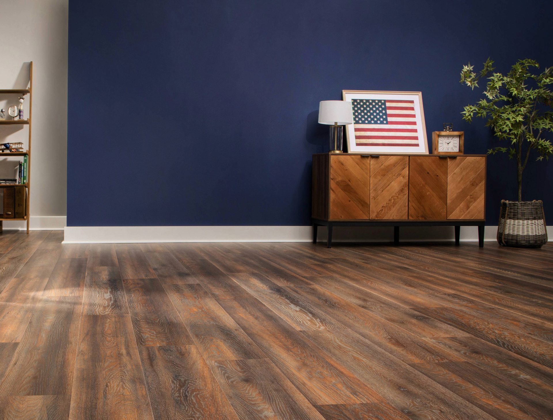 Sunlit living room with warm wide-plank hardwood flooring